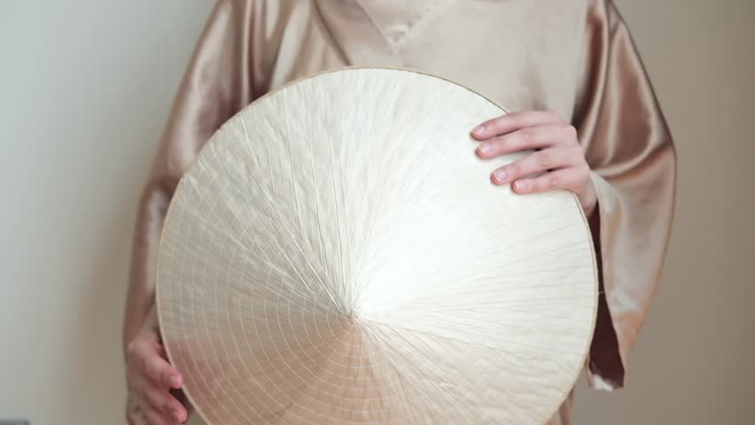 Vietnamese traditional round hat in female hands