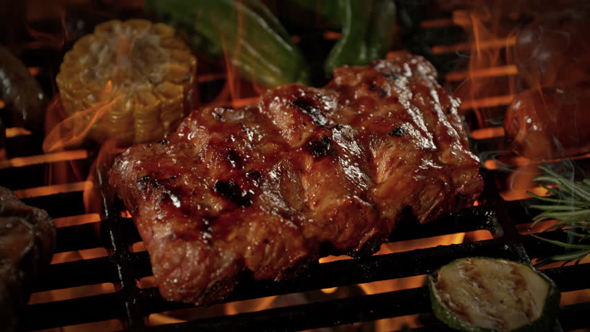 Super Slow Motion Shot of Pork Ribs on Fired Up Grill with Camera Motion at 1000fps.
