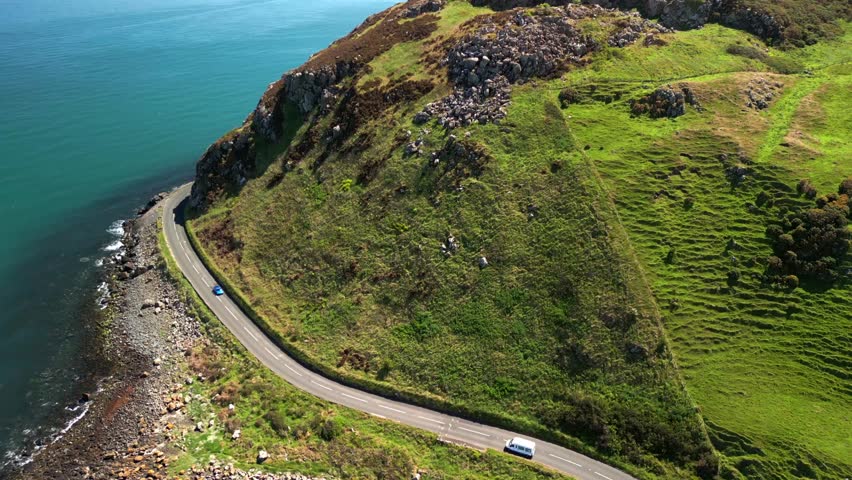 Ascending aerial video of the Antrim Coastal Route on a bright and sunny day. Filmed in Ballygally in 4K, 60FPS and with Rec800 color.