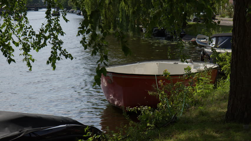 Boats On Canal In Amsterdam, Netherlands - Wide Shot