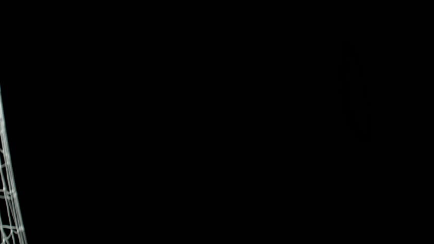 Super Slow Motion Soccer Ball Hitting Goal Net Isolated on Black Background, 1000fps.
