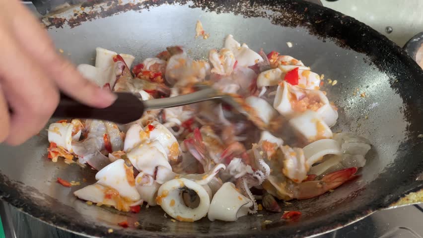 Stir-fried spicy seafood with basil (Stir-fried seafood with basil) A popular Thai dish that is typical of popular Thai street food. The concept of Thai food, original recipes.