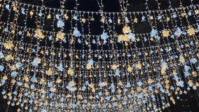 Twinkling Christmas Lights Canopy: Sparkling Golden and White Snowflake Decorations. Magical Winter Night, Festive Celebrations, Vertical Background. - Powered by Shutterstock - Get 15% off with code: PIKWIZARD15