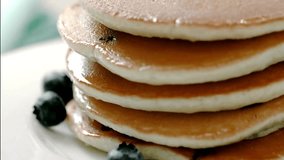 Stack of Pancakes with Melting Butter. adds maple syrup to pancakes in kitchen. Close up video of butter melting on a stack of delicious pancakes. - Powered by Shutterstock - Get 15% off with code: PIKWIZARD15