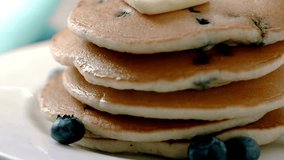 Stack of Pancakes with Melting Butter. adds maple syrup to pancakes in kitchen. Close up video of butter melting on a stack of delicious pancakes. - Powered by Shutterstock - Get 15% off with code: PIKWIZARD15