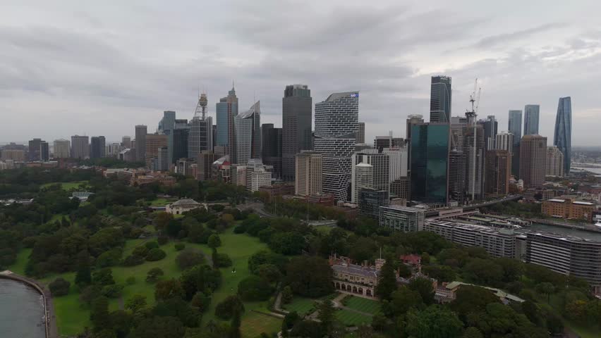 Sydney business district skyline in front of the Royal Botanic Garden.