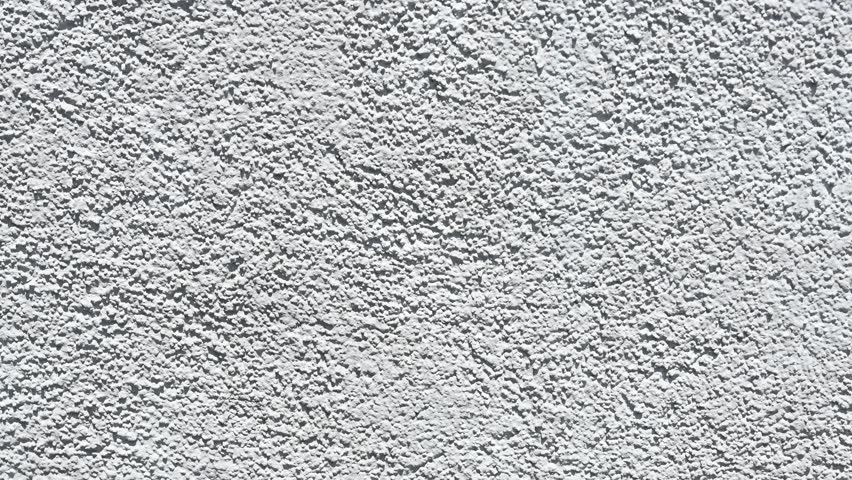 Rough white plaster wall texture background. Close-up of a rough white stucco or plaster wall surface, ideal for backgrounds, textures, or architectural design references.


