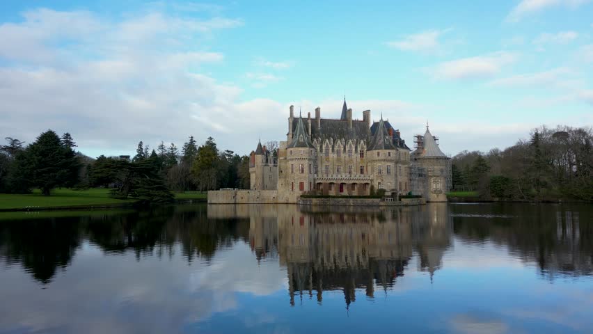Medieval castle on the shore of a river, Chateau de la Breteshe, France, 4k