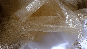 Close up of white golden beige wedding dress lace and fabric. Luxury background, b roll - Powered by Shutterstock - Get 15% off with code: PIKWIZARD15