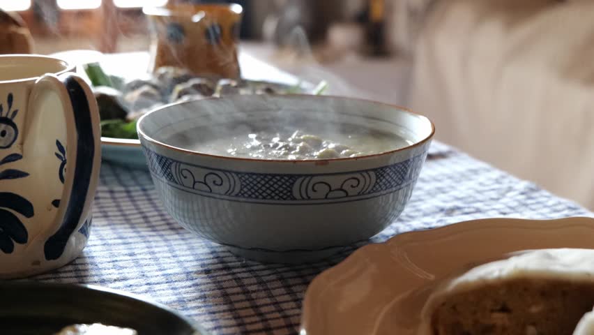 Steaming Bowl of Split Pea Soup Sitting on Kitchen Table