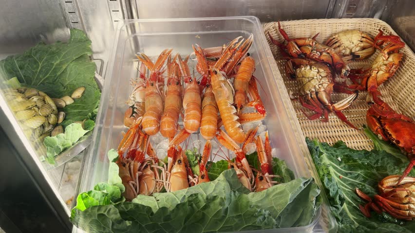 Seafood market. A large selection of crabs, mollusks and shrimp on the counters. High quality 4k footage
