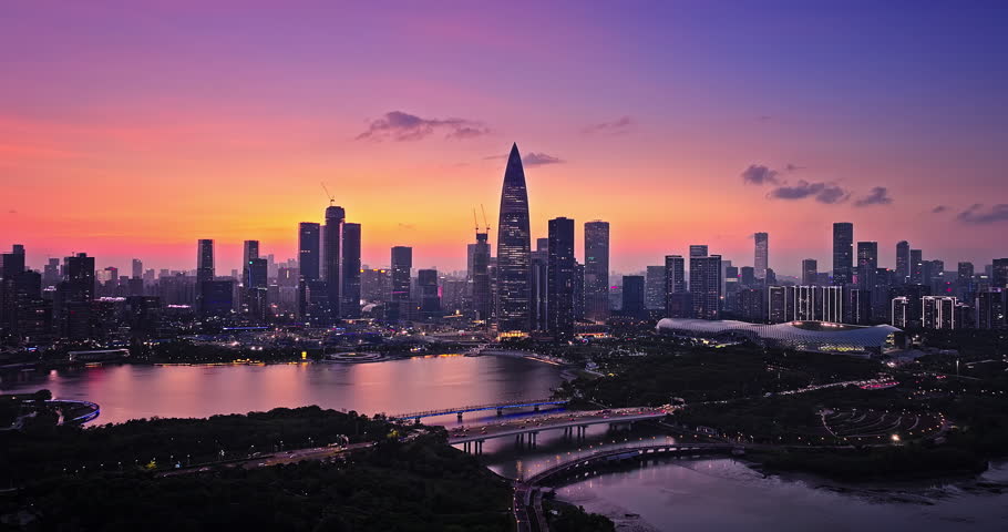 Aerial shot of city skyline and modern commercial buildings at night in Shenzhen, China.