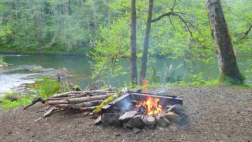 Time lapse of man starting campfire at camp in the Pacific Northwest, Oregon.