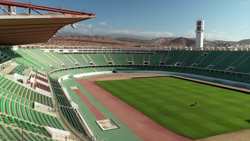 Aerial view inside empty Stade Adrar, showing green football pitch and running track, Agadir, Morocco