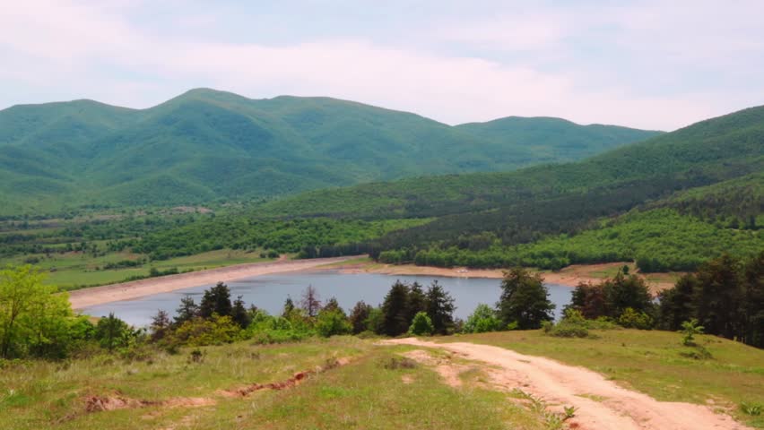 Landscape with a lake and mountains next to it