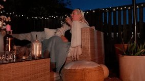 Flickering flames illumination, patio warmth, mature drinking female - Powered by Shutterstock - Get 15% off with code: PIKWIZARD15