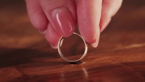 A feeling of love that fades. The woman removes wedding ring from finger. Adultery and divorce concept. High quality 4k footage - Powered by Shutterstock - Get 15% off with code: PIKWIZARD15