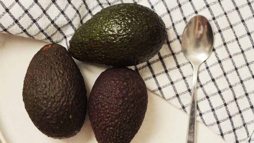 Close up footage of avocado fruit. Avocado popular as a health food, containing good fat. These fats can lower levels of cholesterol. High quality 4k footage