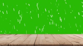 Christmas tree branches on natural wooden table in background and falling snow. Green screen alpha channel. - Powered by Shutterstock - Get 15% off with code: PIKWIZARD15