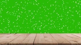 Christmas tree branches on natural wooden table in background and falling snow. Green screen alpha channel. - Powered by Shutterstock - Get 15% off with code: PIKWIZARD15