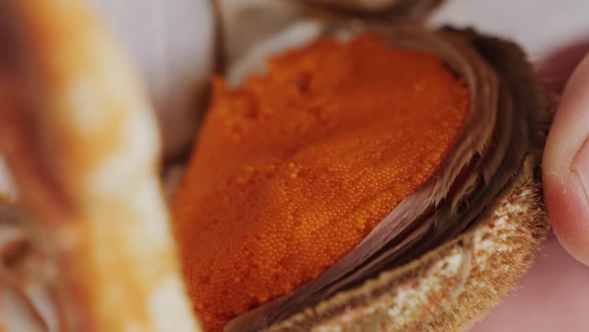 Cooked crabs on ice plate served in restaurante, black slate background, top view.