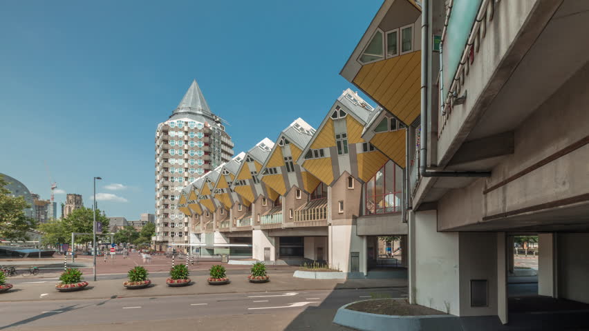 Hyperlapse of Cube House (Kubuswoningen) in Rotterdam. Unique yellow cube-shaped houses showcasing innovative architecture amid cityscape aerial timelapse. Cloudy sky and urban vibrancy. Netherlands