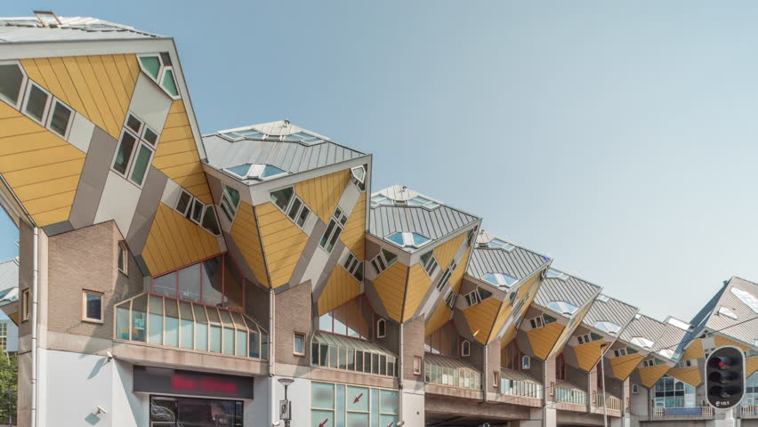 Hyperlapse of Cube House (Kubuswoningen) in Rotterdam. Unique yellow cube-shaped houses showcasing innovative architecture amid the cityscape timelapse. Blue sky and urban vibrancy. Netherlands
