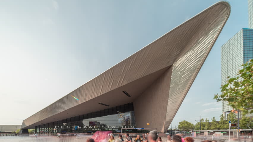 Hyperlapse of Rotterdam Central Station, the main railway hub in South Holland, Netherlands. Modern architecture with skyscrapers in the background and busy people on the square timelapse