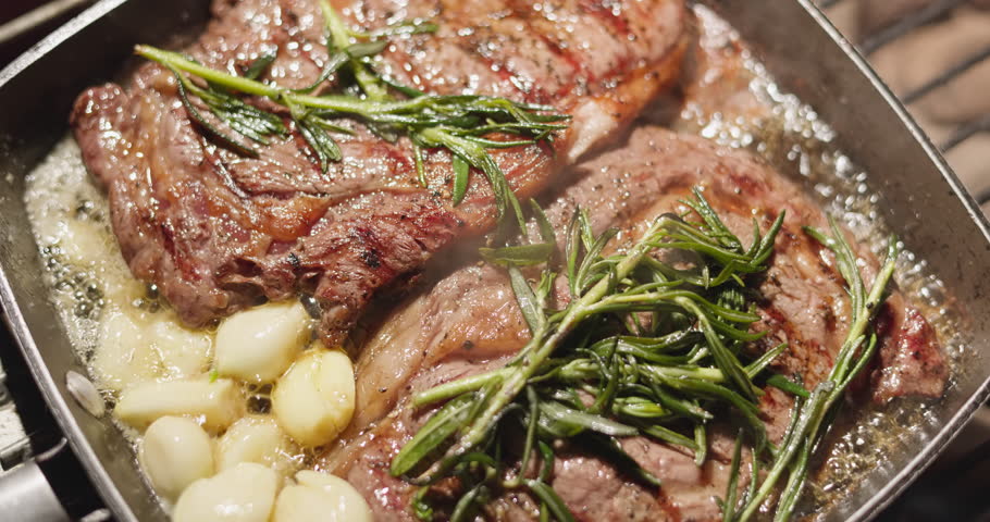 barbecue party, close-up footage of grilling steaks, spiking pieces of meat on the grill, various vegetables, lots of smoke