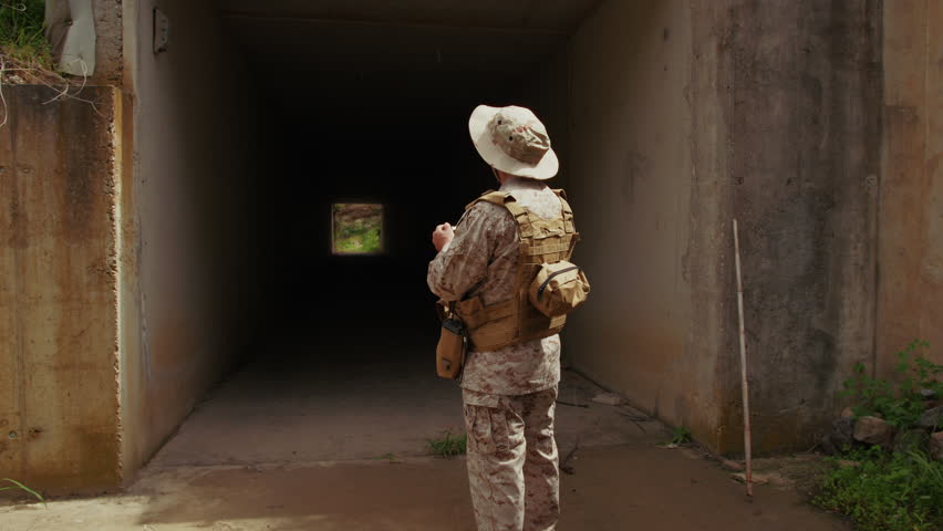 War Journalist In Uniform Taking Photos At An Old Building 