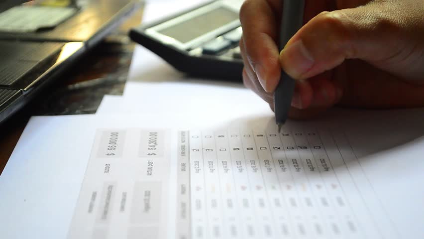 Checking boxes with a pen on a white sheet of paper. Filling out the budget checklist. Calculate and fill in the shopping budget checklist box
 - Powered by Shutterstock - Get 15% off with code: PIKWIZARD15