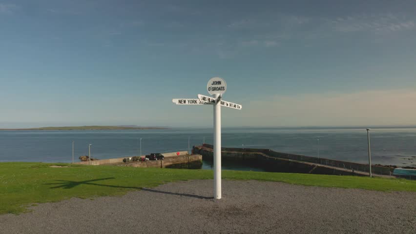 John O'Groats harbour and famous signpost landmark on a summers day