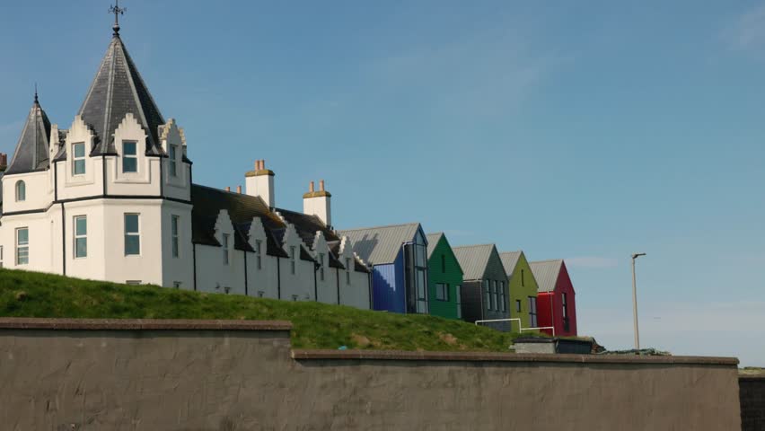 low angle shot of multicoloured hotel apartments at John O'Groats on the NC500 route