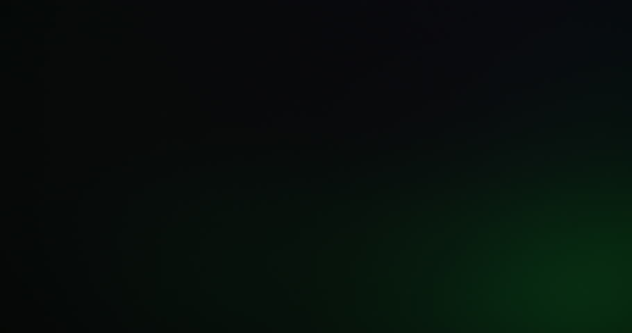 Optical blur transition. Lens leak. Green beam film luminosity on black background. Color light motion overlay fade in abstract darkness.