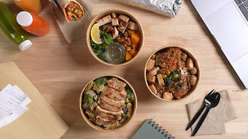Having a lunch break at the office with delicious Healthy food delivery in take away boxes, Healthy eating concept.
