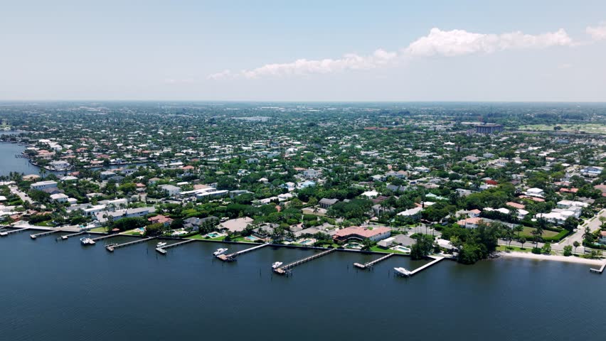 Aerial flyover along Flagler Beach with palm trees and sea near West Palm Beach