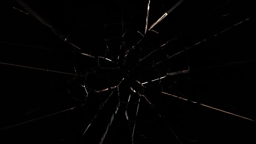 Glass exploding outwards from center on black background. Shatter effect, impact, destruction concept for dynamic visuals or transitions