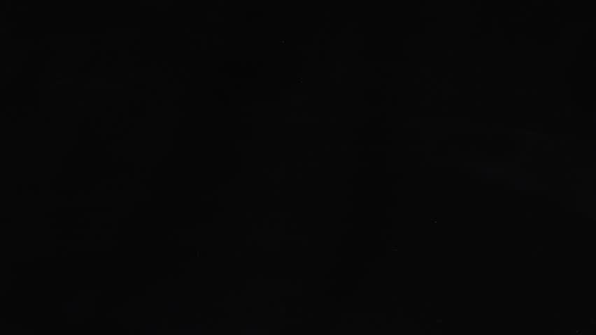 Glass slowly cracking and shattering on black background. Abstract effect for impact, breaking, or transition. Minimalist video