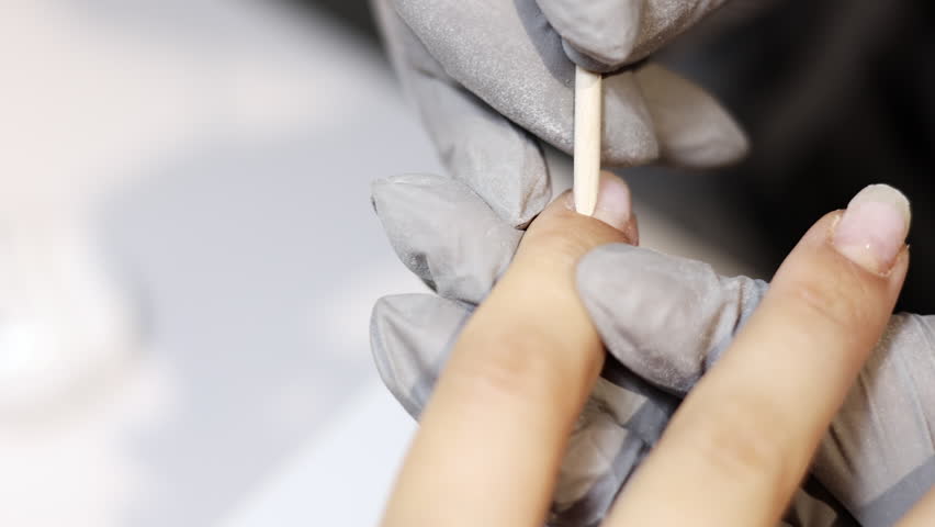 nail master applying gel polish, step by step guide.manicurist is using a nail file,drill, first,remove cuticle with nipper and push with stick.woman buffing,clean,degrease and using uv lamp.