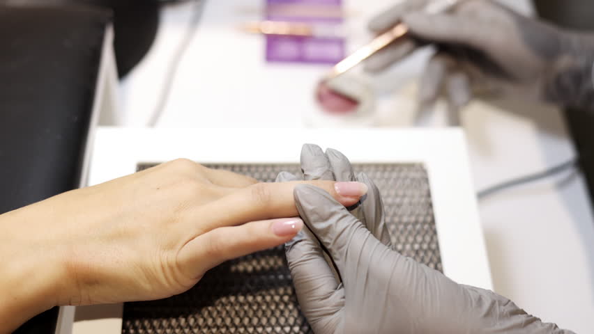 nail master applying gel polish, step by step guide.manicurist is using a nail file,drill, first,remove cuticle with nipper and push with stick.woman buffing,clean,degrease and using uv lamp.