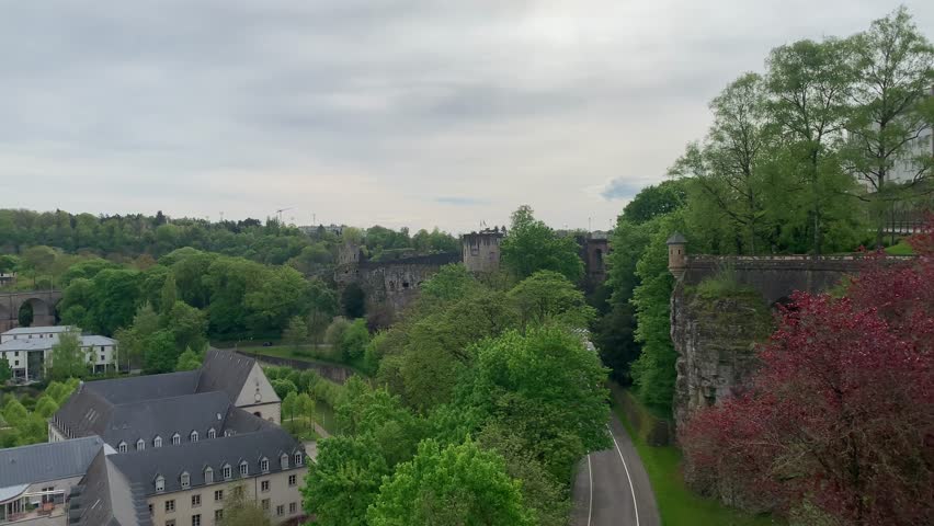 Panoramic, scenic view of Pfaffenthal and Grund neighbourhoods. Ruins of the Fortress of Luxembourg. Pont de Chemin de Fer Bridge. Luxembourg City, Luxembourg