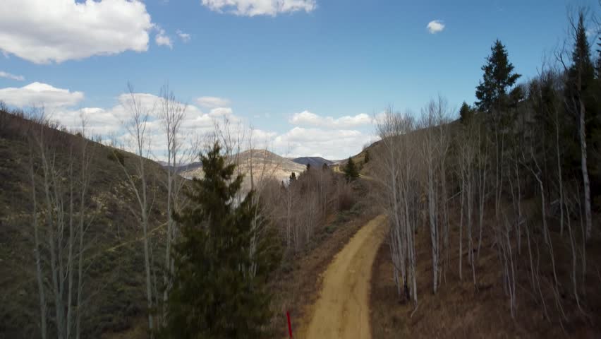 Scenic drone flyovers of Strawberry Reservoir in Utah, featuring alpine forests, rivers, rocky terrain, and vibrant spring colors in cinematic aerial views.