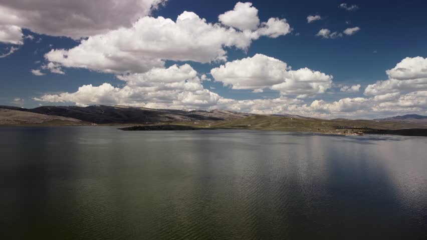 Scenic drone flyovers of Strawberry Reservoir in Utah, featuring alpine forests, rivers, rocky terrain, and vibrant spring colors in cinematic aerial views.