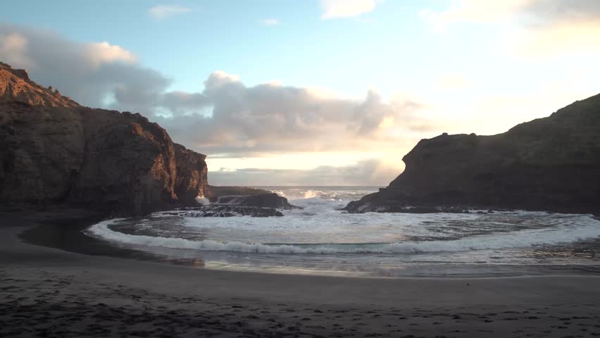 Beautiful lagoon and ocean beach in Piha, Auckland, New Zealand, before sunset.