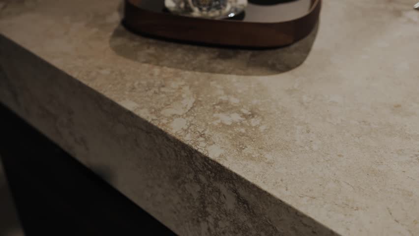 Textured white marble surface in a kitchen with gorgeous wood decor, camera moves slowly back creating a stunning aesthetic
