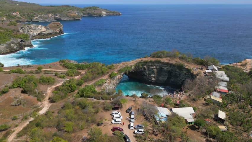 Aerial view of Broken Beach and Angel's Billabong on Nusa Penida, Bali. Famous coastal rock formation with natural arch and turquoise waters. Ideal for travel and nature themes.