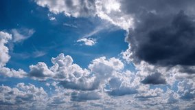 Accelerated view shows voluminous cloud formations billowing and drifting across a sun-drenched sky. Darker grey masses contrast with bright white puffs, showcasing dynamic atmospheric changes. - Powered by Shutterstock - Get 15% off with code: PIKWIZARD15