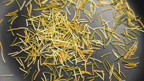 Colored angel hair vermicelli falling on black ceramic plate. Italian uncooked pasta. Rotation. Slow motion. Top view - Powered by Shutterstock - Get 15% off with code: PIKWIZARD15