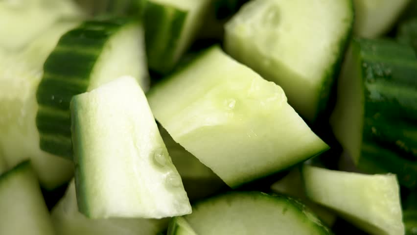 Vegetable salad with chopped fresh raw cucumbers. Green organic ingredients. Macro shot. Rotation