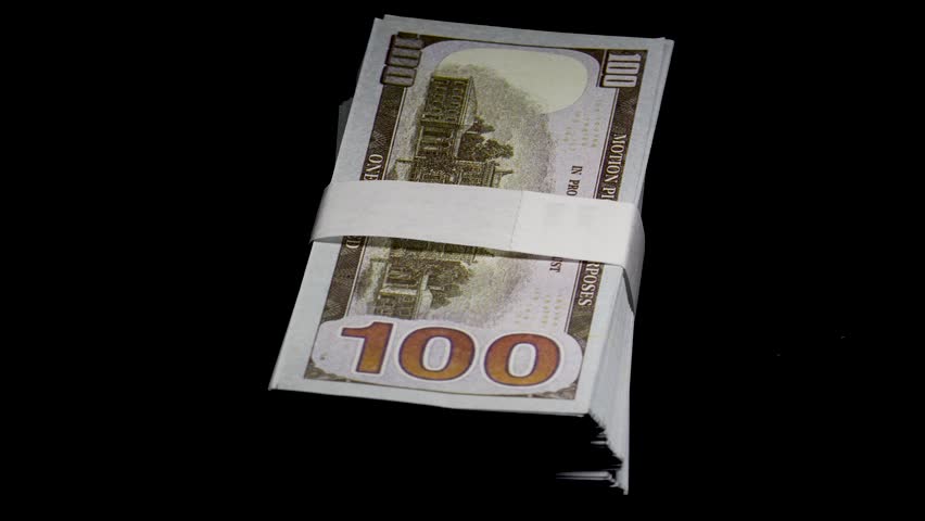 A stack of 100 hundred-dollar bills on a black background with beautiful lighting, 360-degree rotating video. 4k video.